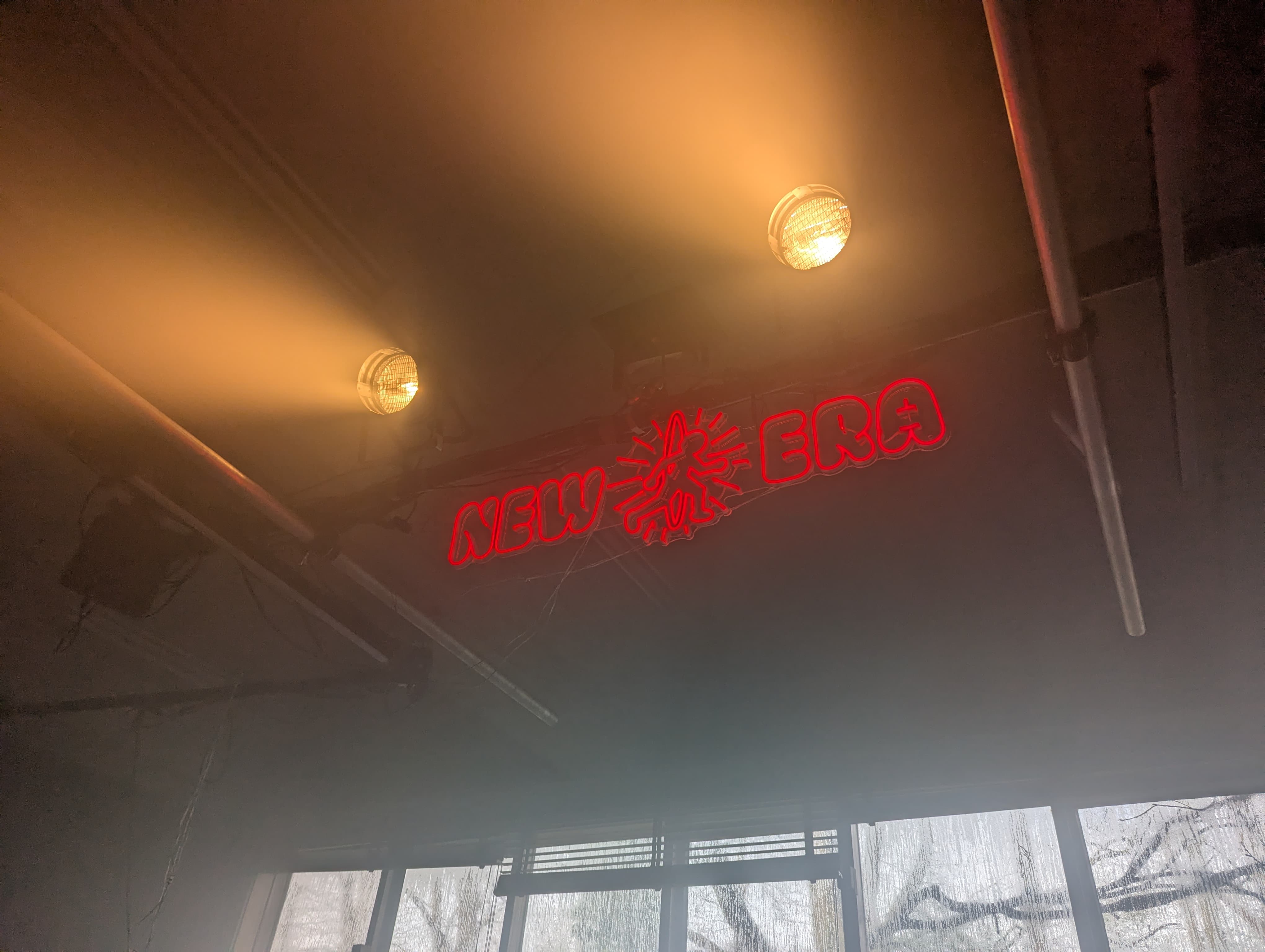 New Era neon sign under the venue ceiling