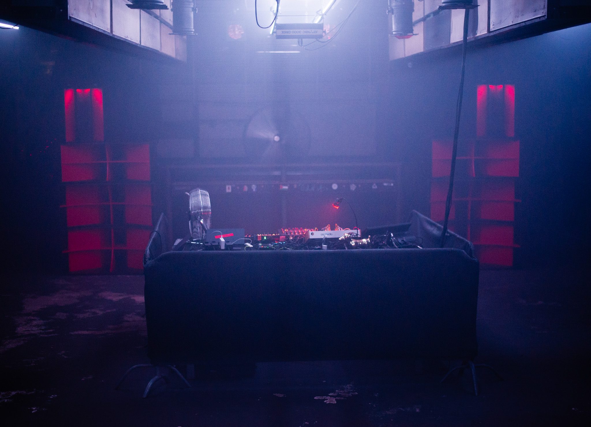 DJ booth lit in blue haze